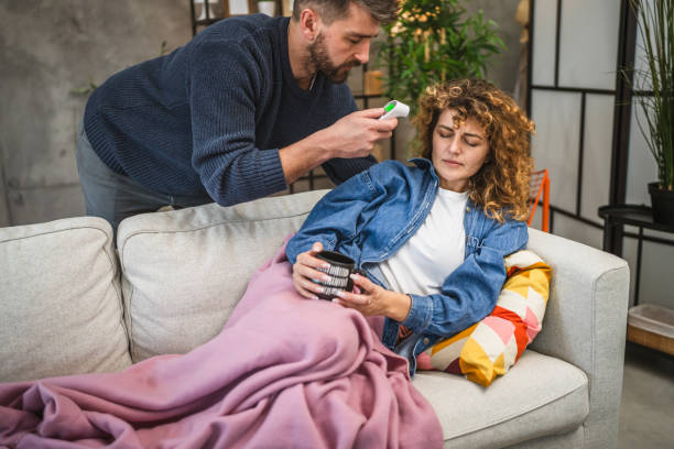 istock A man measures a woman temperature with a digital infrared thermometer 2196450399