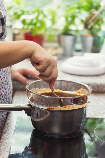 Woman making chocolate glaze for brownies