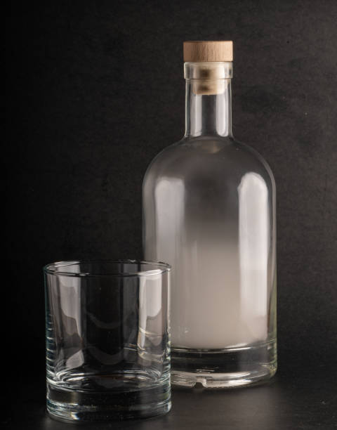 istock Smoke-Filled Bottle and Empty Glass Tumbler 2196452361