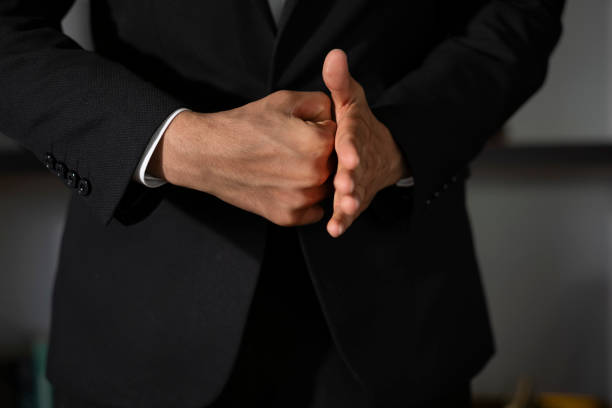 istock Businessman clenching fist and open hand together 2196452459