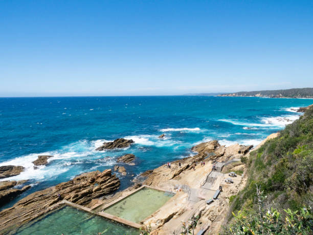 istock Ocean swimming pool surrounded by rocky coastline 2196452887