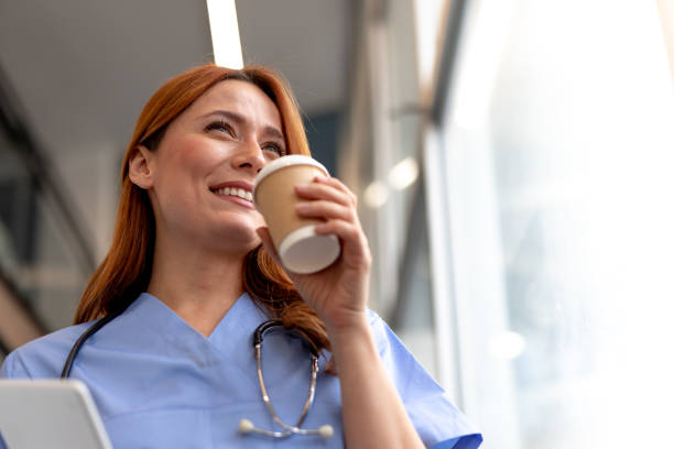 istock Smiling doctor drinking coffee during a break at the hospital 2196453045