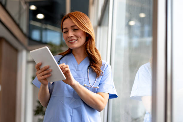 istock Smiling Nurse Using a Tablet in a Modern Healthcare Facility 2196453056