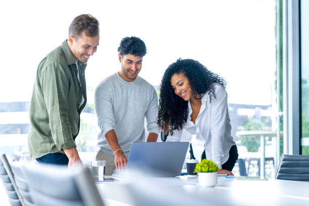 istock Team of three business people working on a laptop computer. 2196453157