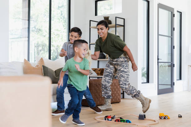 istock Happy Military Mom Playing with Her Sons at Home 2196455449