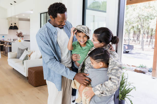 istock Happy Family Reunion: Soldier Mom Home with Kids 2196455459