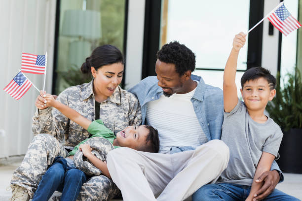 istock Happy Multiracial Family with American Flags Celebrating 2196455481