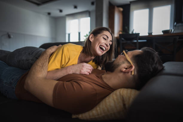 istock Loving couple wrapped in each other's arms on the sofa 2196455515