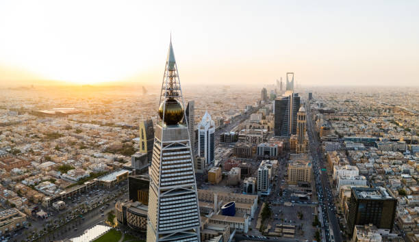 Al Faisaliah Tower pyramid-shaped commercial skyscraper. Riyadh. Drone shot flying. Sunset. Evening. Al Faisaliah Tower is a striking pyramid-shaped skyscraper in the heart of Riyadh, Saudi Arabia. Its unique design, which is a graceful pyramid with a distinctive golden glass sphere at the top, sets it apart from the rest of Riyadh's skyline. High-quality photo