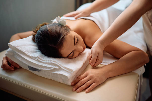 istock Young woman relaxing during massage at wellness spa. 2196459491