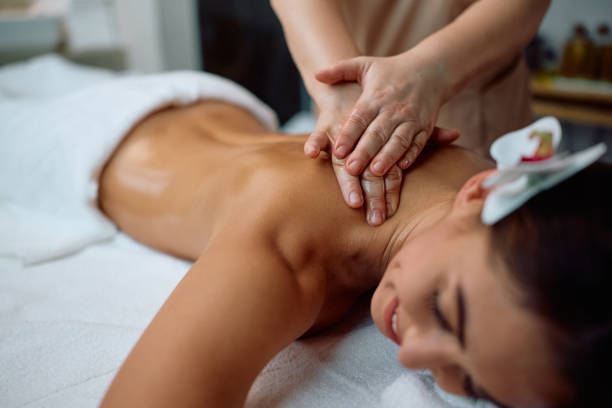 istock Close up of therapist massaging woman's back at the spa. 2196459571
