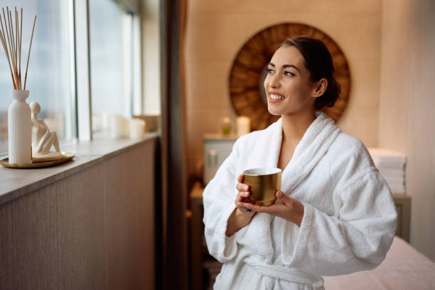 istock Happy woman with cup tea enjoying in relaxing spa day. 2196459796