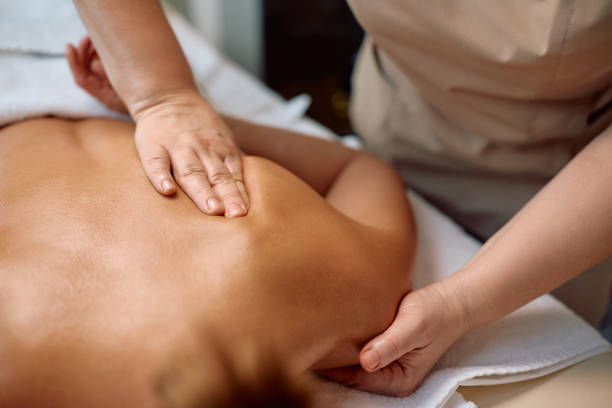 istock Close up of masseuse massaging woman's shoulder during back massage at the spa. 2196459813