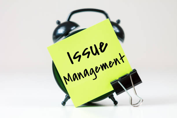 istock Issue Management inscription on paper with alarm clock 2196462555