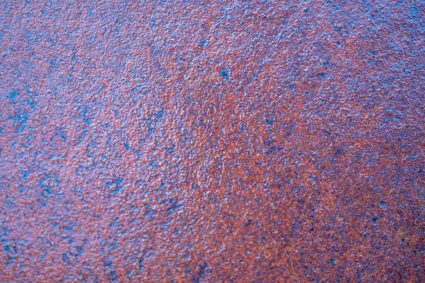 The image is of a rusty surface with a blue tint. The surface is rough and has a lot of texture. The blue tint gives the image a moody and somewhat ominous feel