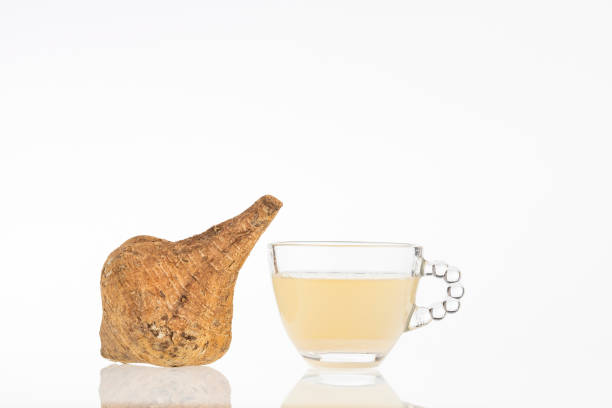 Organic maca powder dissolved in water - Peruvian Lepidium meyenii root. Maca powder of Peruvian origin, dissolved in water - Lepidium meyenii pachyrhizus erosus stock pictures, royalty-free photos & images