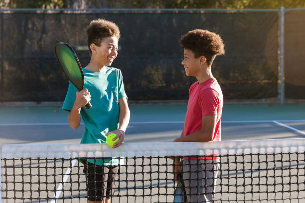 istock Young brothers playing pickleball on sunny court 2196468112