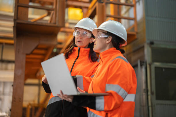 istock Two Engineers Discussing In Modern Industrial Factory 2196471252