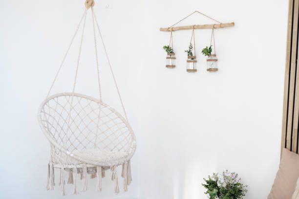 istock Cozy hanging chair with greenery decor in a bright indoor space 2196471853