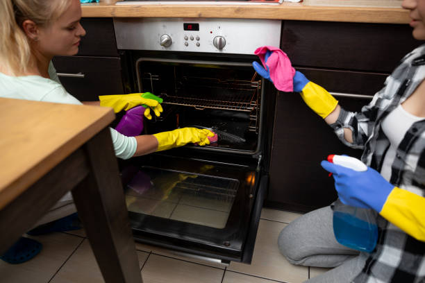 istock Two Women Engaged in a Collaborative Effort to Deep Clean an Oven Together Efficiently 2196476698