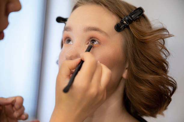 istock A skilled Makeup Artist is meticulously applying eye makeup on a stunning models eyes 2196477805
