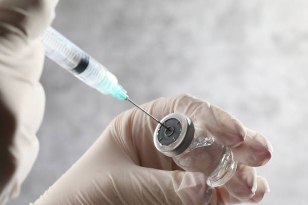 istock close up of doctor hands holding syringe 2196479123