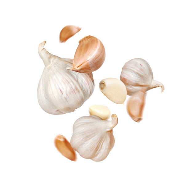 istock Garlic levitating in the air close-up on white background. Falling garlic cut out on white background 2196481251