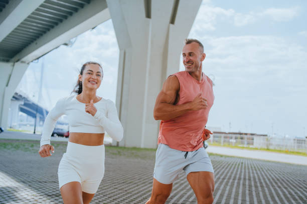 istock Couple enjoying a sunny run under the bridge 2196482781