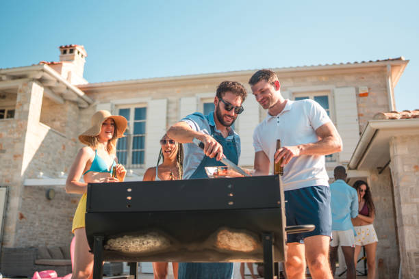 istock Hispanic Chef Mastering the BBQ Grill by the Pool 2196483176