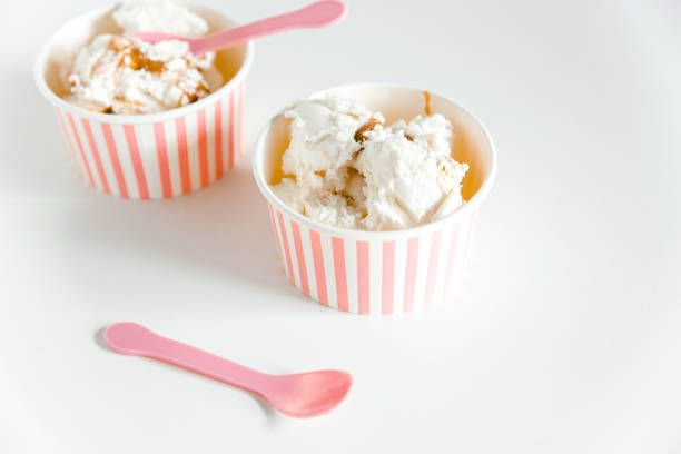 Ice cream boxes and cute pink spoons. White background