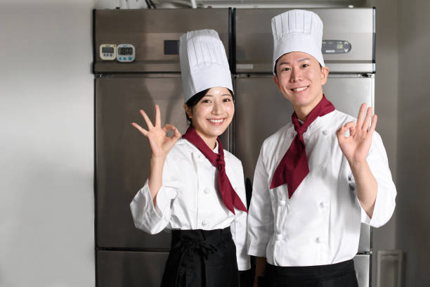 istock Male and female cooks posing in the kitchen 2196487241