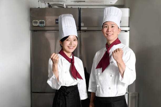istock Male and female cooks posing in the kitchen 2196487548