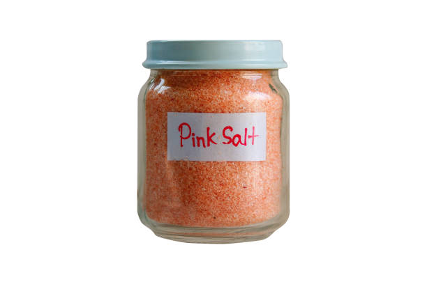 istock Glass jar of pink salt isolated on a white background. Selective focus,Clipping path 2196488247