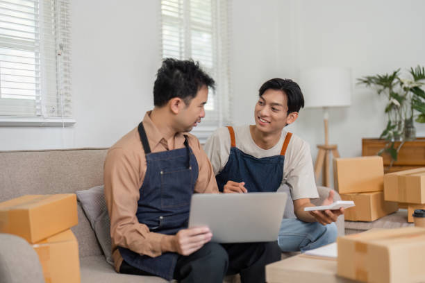 istock Small business partners discussing strategy while preparing packages at home office 2196488252