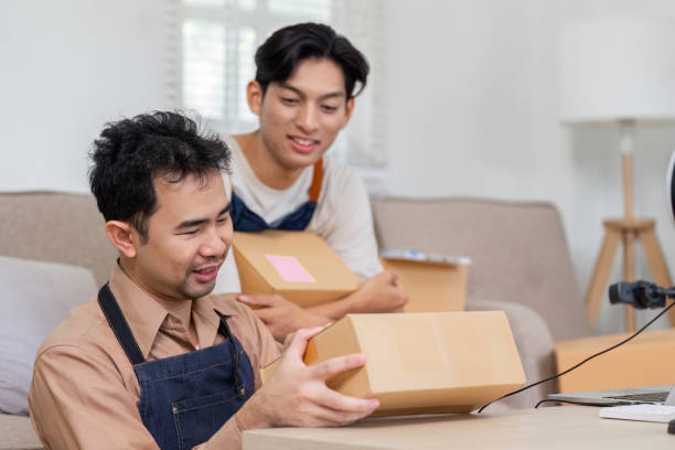 istock Two young delivery professionals excitedly inspecting packages together in a bright office environment 2196488344
