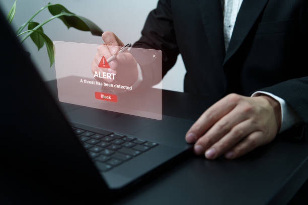 istock Person Using Laptop with Cybersecurity Threat Alert 2196490788