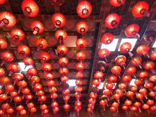 istock Red Lanterns Ceiling: Hundreds of vibrant red lanterns hang from a ornate ceiling, creating a captivating and festive atmosphere. Perfect for celebrating Lunar New Year, cultural events. 2196494038