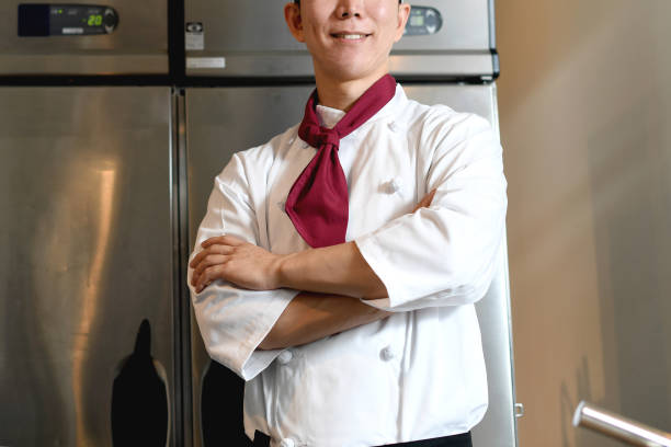istock Smiling male chef with arms crossed looking at camera in the kitchen 2196494202