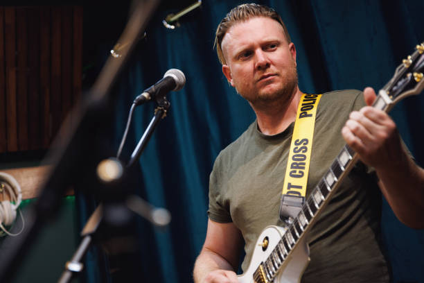 Guitarist playing in rehearsal space