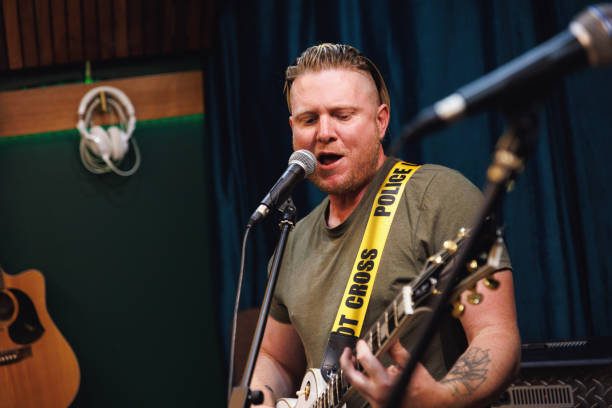 istock Rock singer and guitarist performing in the studio 2196495767