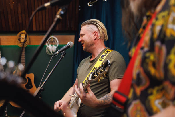 istock Rock singer and guitarist performing in the studio 2196495787