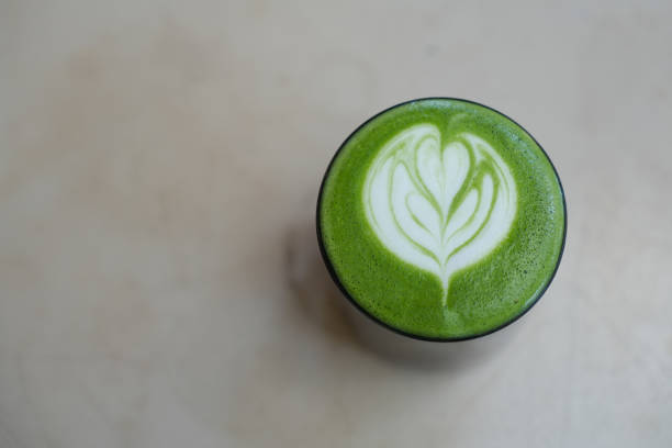 istock A cup of green tea matcha latte on table background. 2196497066
