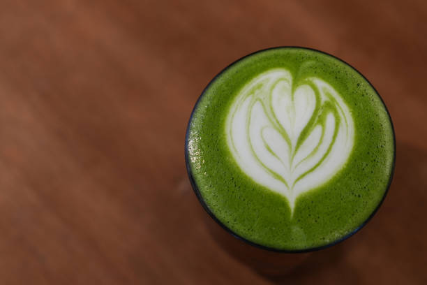 istock A cup of green tea matcha latte on brown table. 2196497068