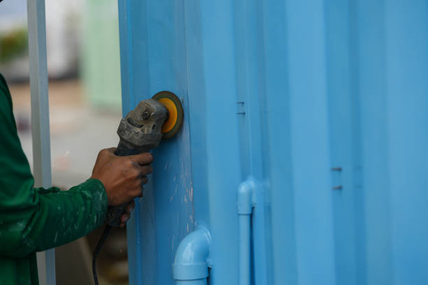 istock Paint and rust removing from metal plate, worker using wire brush at grinder power tool. 2196497128