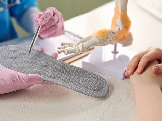 istock Doctor installing a custom orthopedic insole on a patient foot concept 2196498493