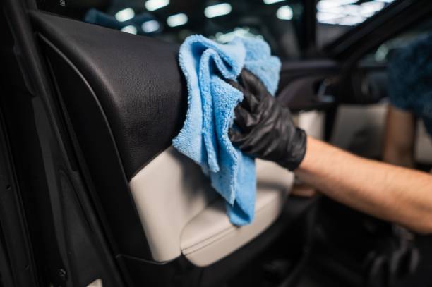 istock A man wipes the surface of the car interior with a microfiber cloth. 2196498873
