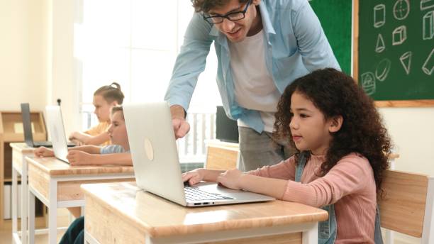 istock American girl learning about prompt while student sitting at class. Pedagogy. 2196499851