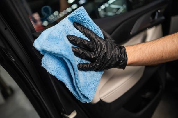istock A man wipes the surface of the car interior with a microfiber cloth. 2196499930