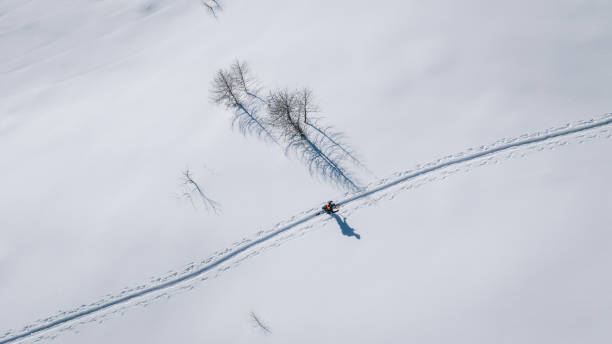 istock Bird's-eye view of backcountry splitboarder climbing mountain 2196500880