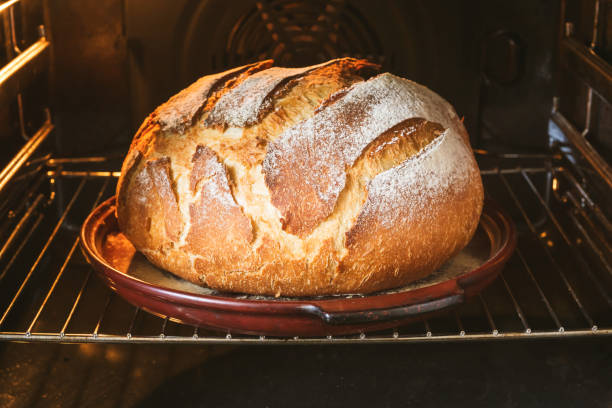 istock loaf of bread. ready-baked bread on a ceramic pan in the oven with a crispy crust. 2196501265